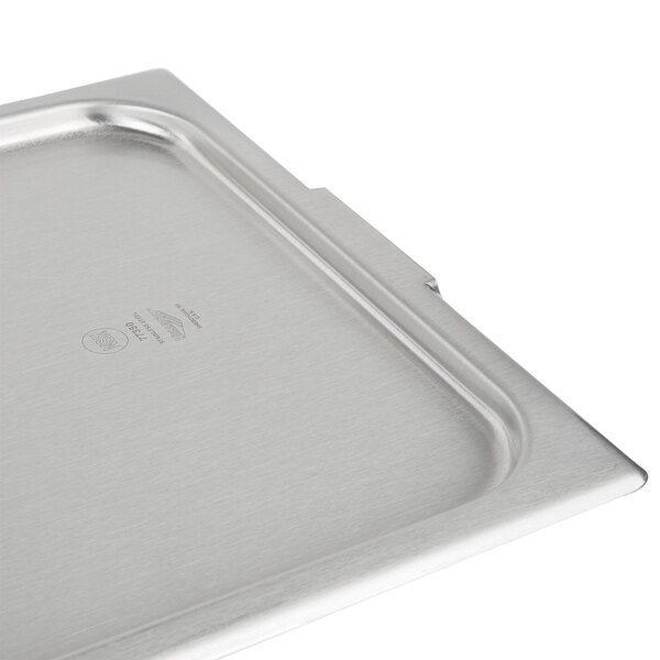 A Vollrath stainless steel steam table pan cover on a tray.