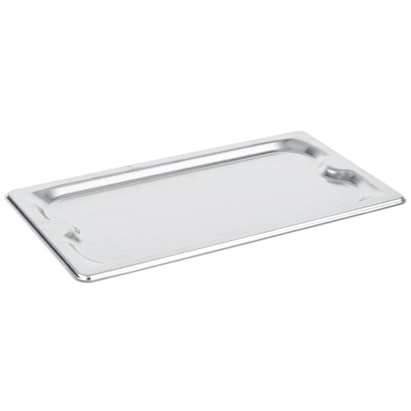 A Vollrath Super Pan 3 stainless steel 1/3 size cover on a tray.