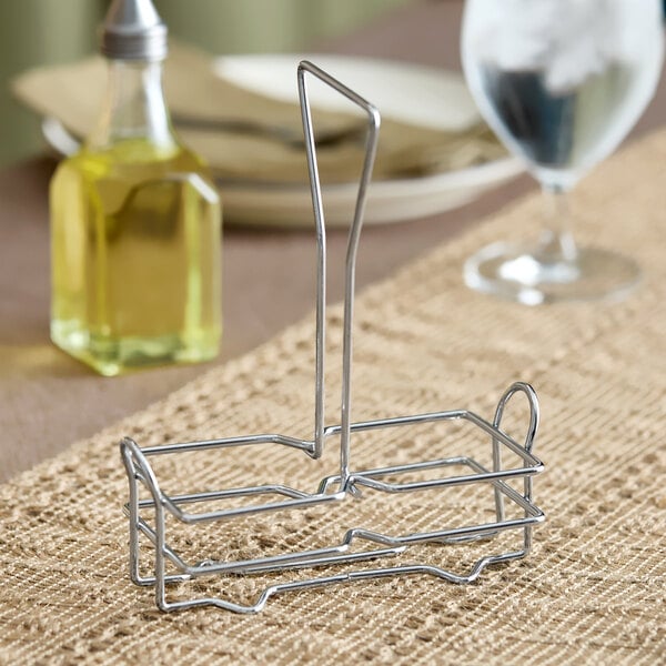A metal wire rack designed to hold a 6 oz. olive oil cruet.