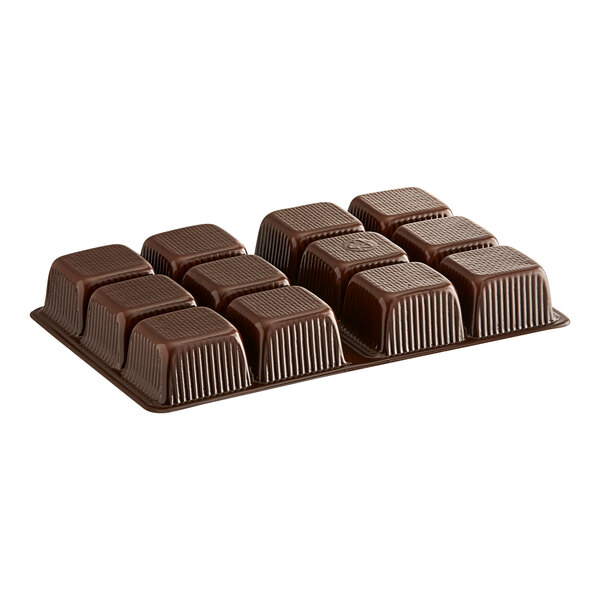 A brown 12-cavity candy tray filled with chocolate cubes.