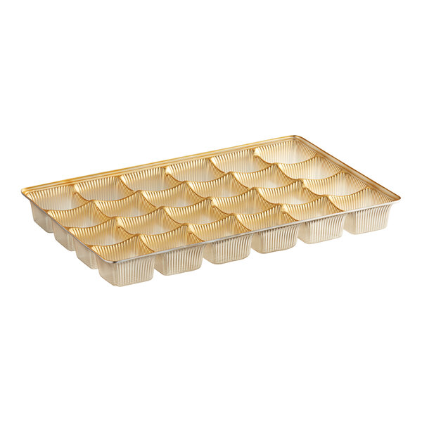 A gold plastic candy tray with 24 cavities.