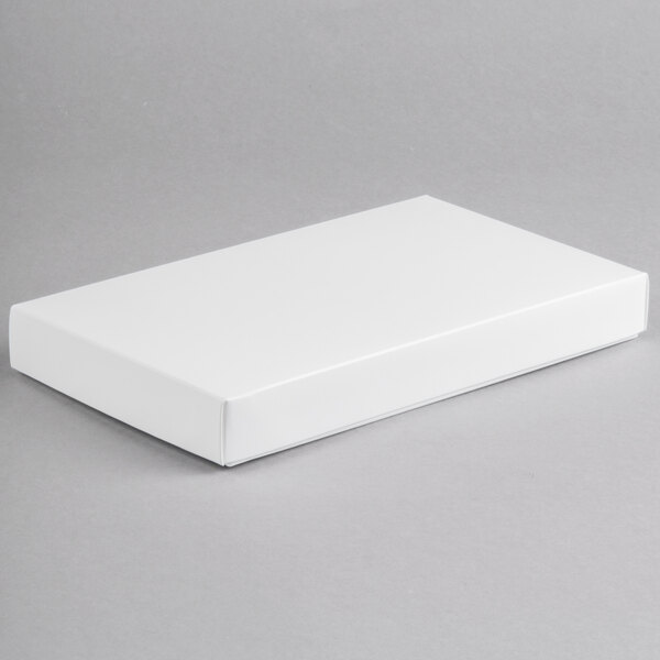 A white rectangular 2-piece candy box on a gray surface.