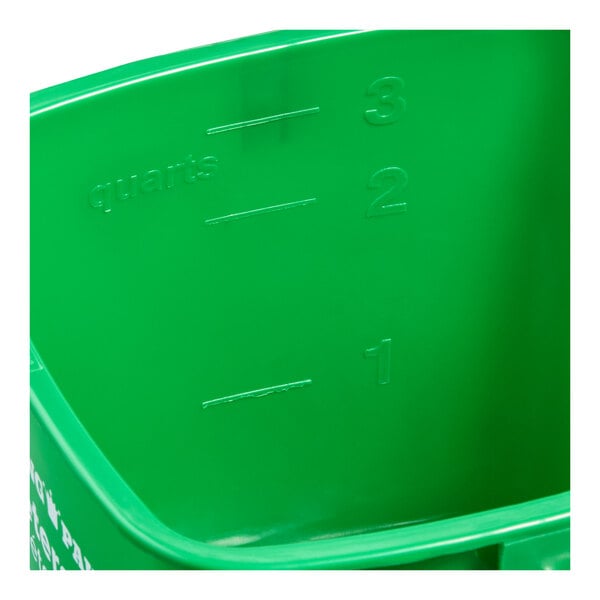 A green plastic cleaning pail with quart measurement markings on the inside.