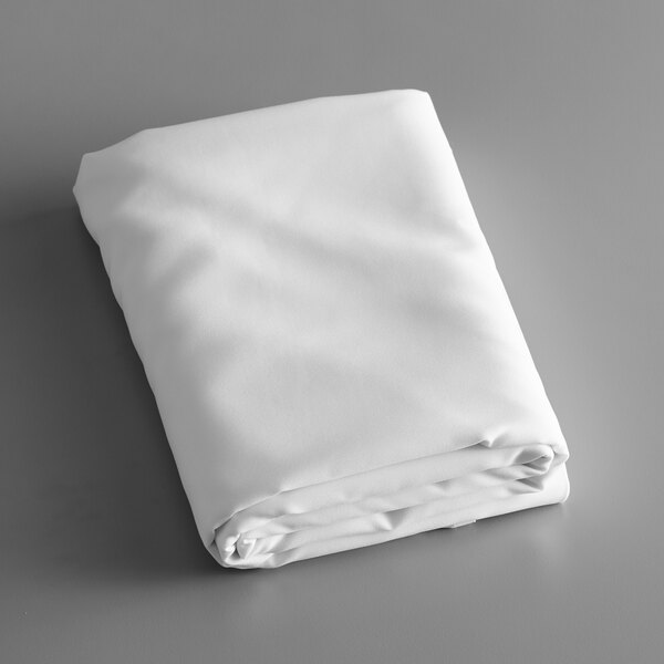 A folded white Intedge round table cover on a gray surface.