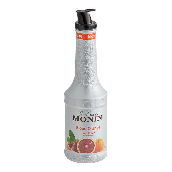 A white Monin bottle of Blood Orange Fruit Puree with a black lid on a counter.