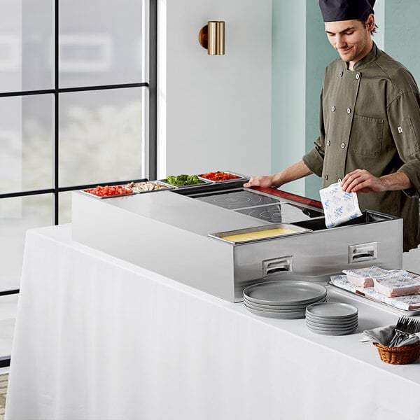 An Avantco induction omelet and pasta station on a table at a buffet restaurant.