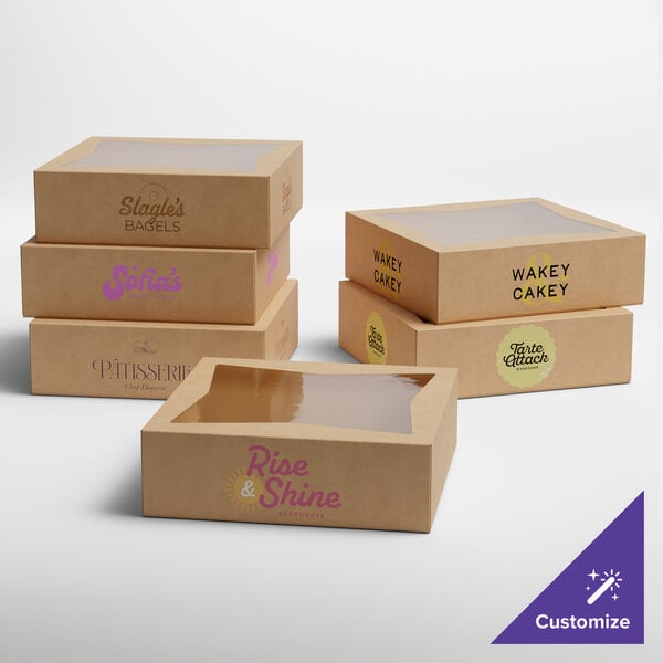 A set of customizable kraft bakery boxes with clear window lids, shown in various designs and stacked together.