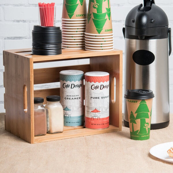 An American Metalcraft bamboo wood crate on a table with coffee cups and a coffee maker inside.