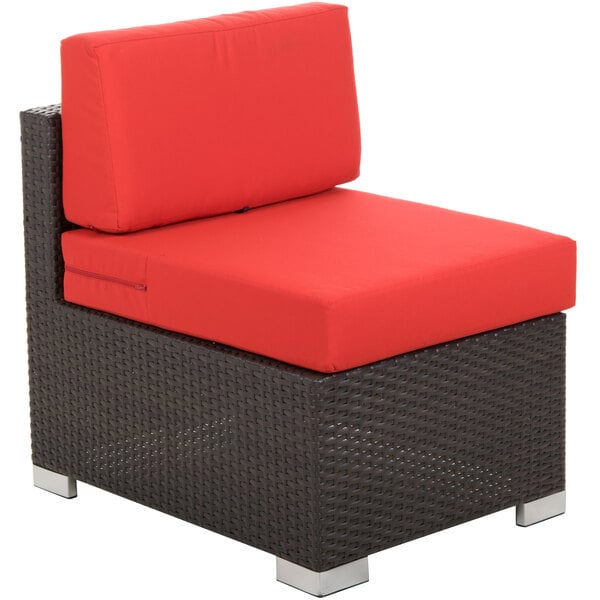 A BFM Seating Aruba Java wicker armless chair with a red cushion.