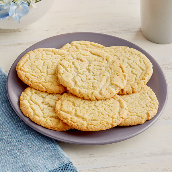 A plate of sugar cookies on a table.