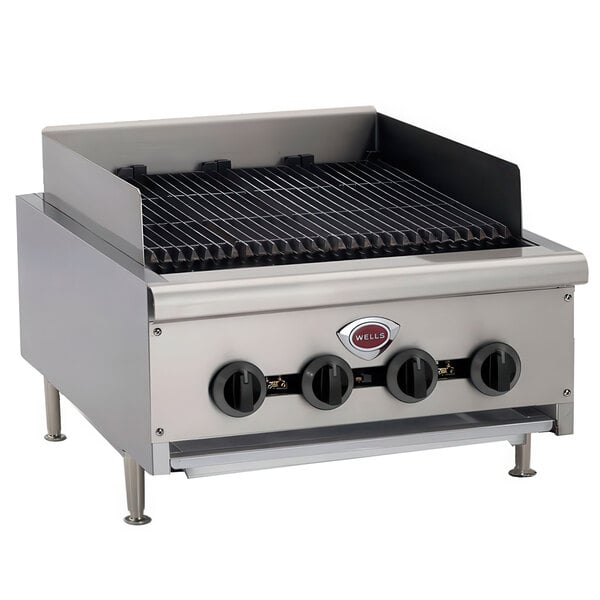 A Wells natural gas charbroiler with four stainless steel burners and black knobs.