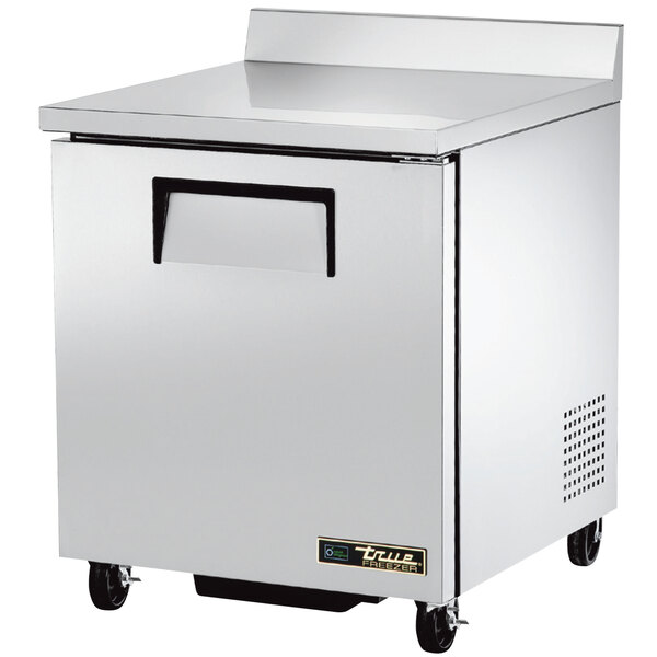 A silver True worktop freezer with a single door on wheels.