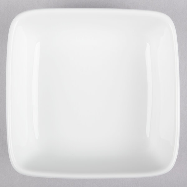 A white square bowl with a white rim.