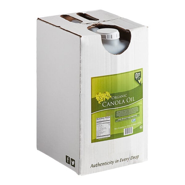 A large white box with a green label containing organic canola oil, featuring a visible plastic cap through a cutout on the top.