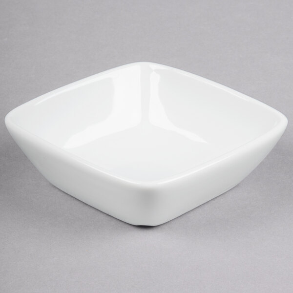 A Libbey Chef's Selection white square bowl on a gray surface.