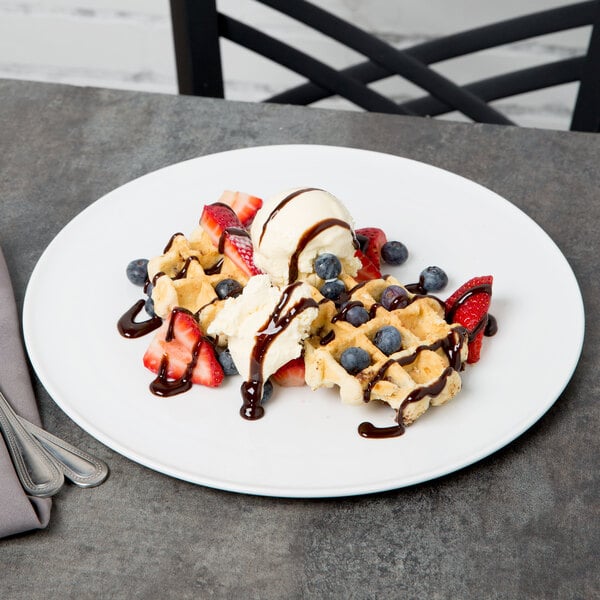 A Libbey aluma white porcelain tray with waffles, ice cream, and strawberries.