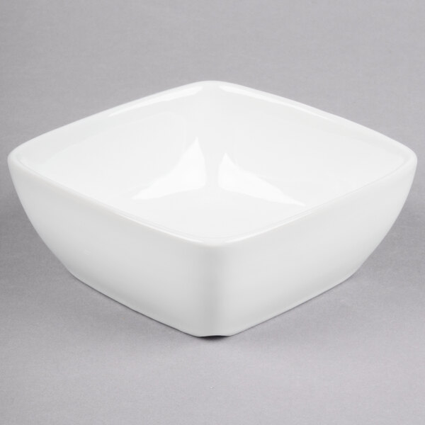 A Libbey white square bowl on a gray surface.