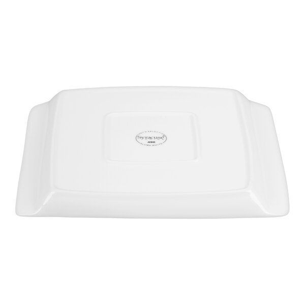 A rectangular white porcelain platter with handles, shown upside down to display the manufacturer's mark on the bottom.