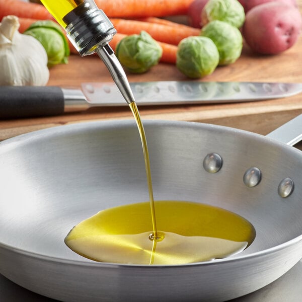 Sunflower oil being poured into a frying pan