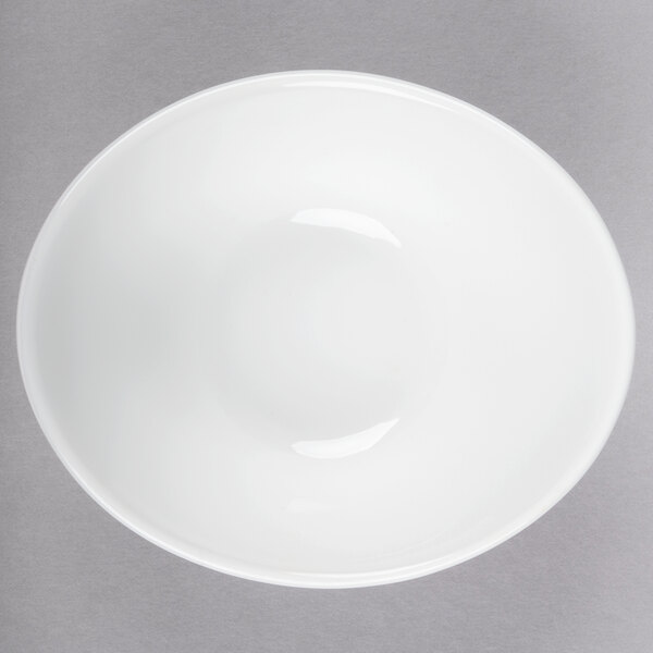 A Libbey aluma white porcelain infinity bowl with a curved edge.