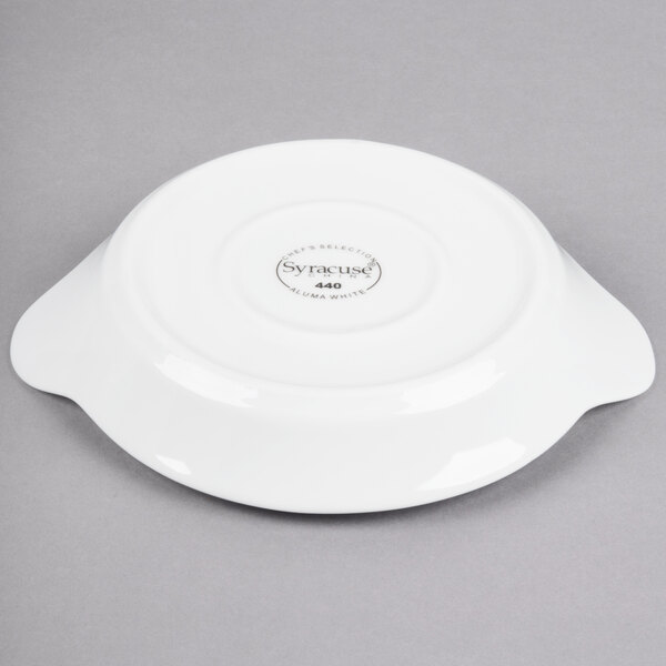 A white Libbey porcelain dish with a handle.