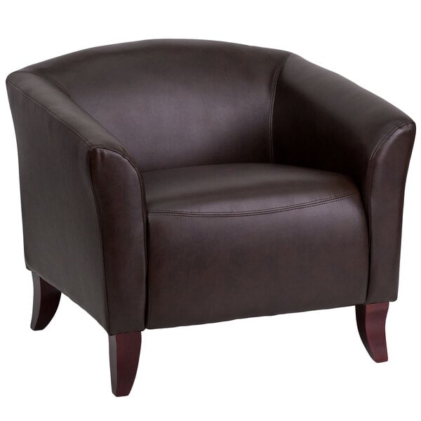 A Flash Furniture brown leather chair with wooden legs.