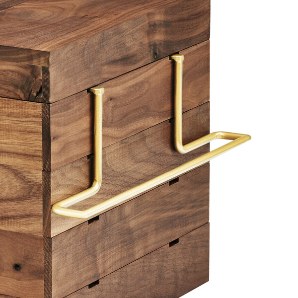 A wooden box with brass shelf brackets on a table.