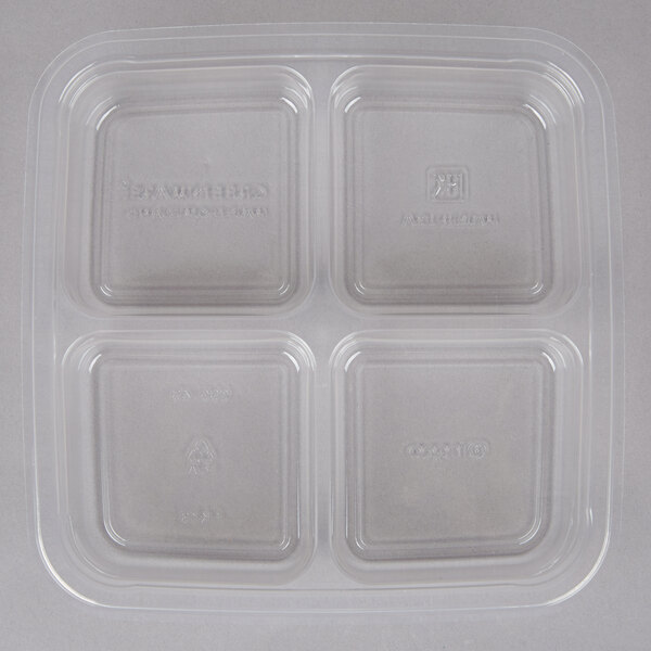 A clear square Fabri-Kal plastic container with four compartments.