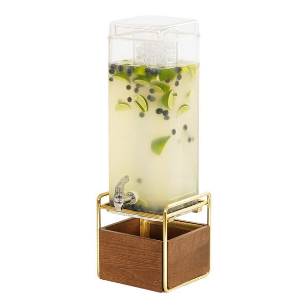 A Cal-Mil square beverage dispenser with a wooden stand filled with a drink on a counter.