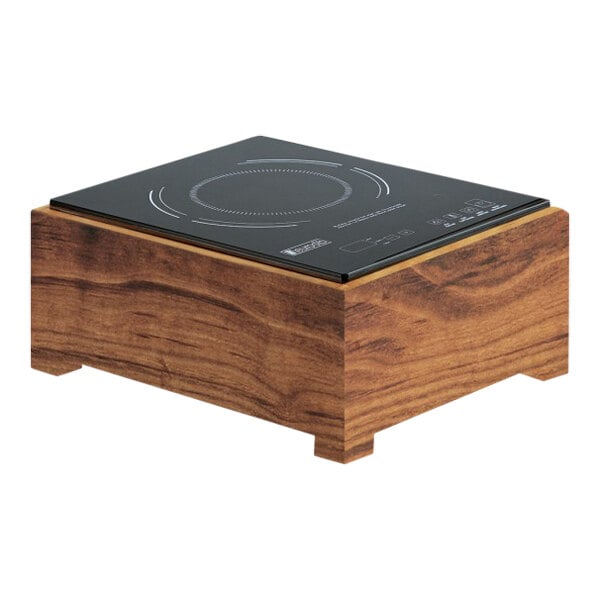 A black Cal-Mil countertop induction cooker on a walnut wooden stand.