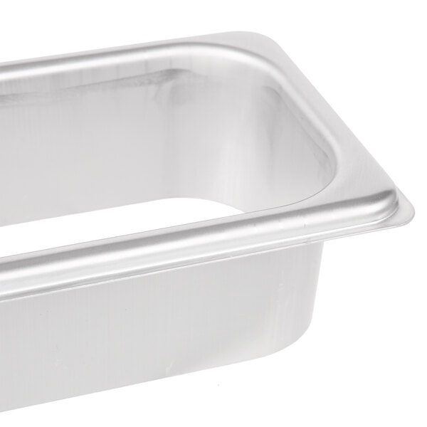 A Vollrath stainless steel rectangular tray with a hole in it.