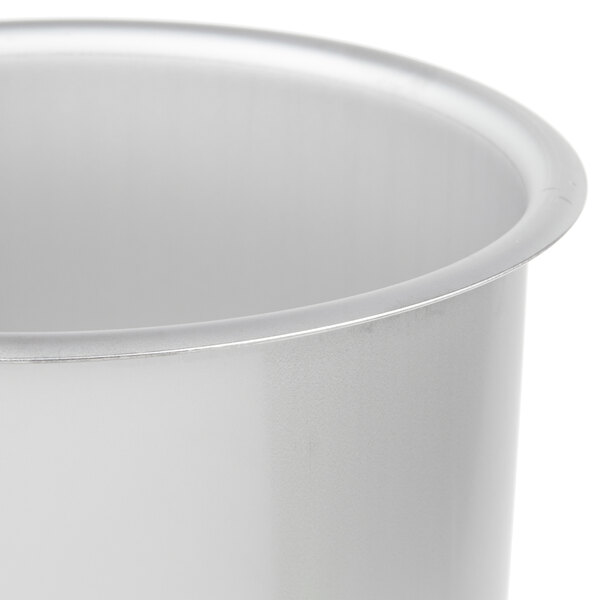 A close up of a silver Vollrath in-counter trash chute.