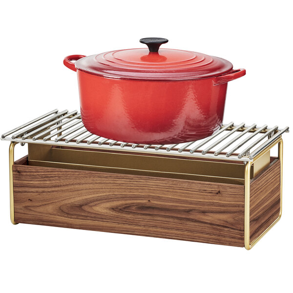 A red pot with a lid on a walnut and brass Cal-Mil chafer alternative rack.