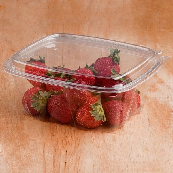 A Dart ClearPac plastic deli container of strawberries with a dome lid.