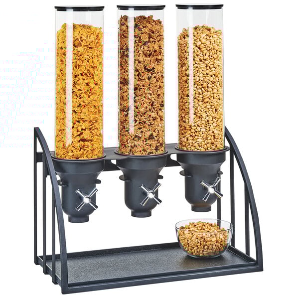 A black Cal-Mil triple cereal dispenser with glass containers filled with cereal.