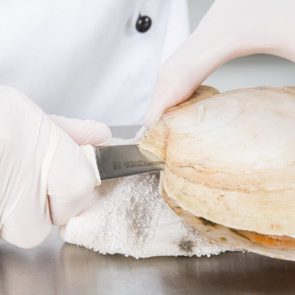 a person cutting a piece of food