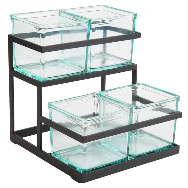 A black metal 2-step stand with 3 glass containers holding condiments.