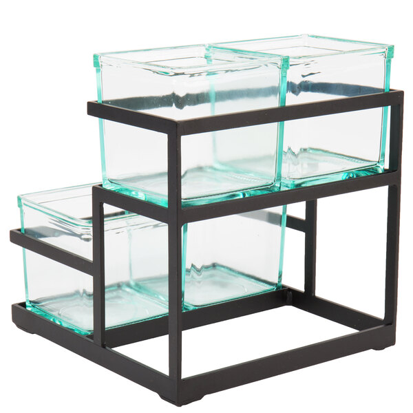 A glass container on a black metal stand with three trays.