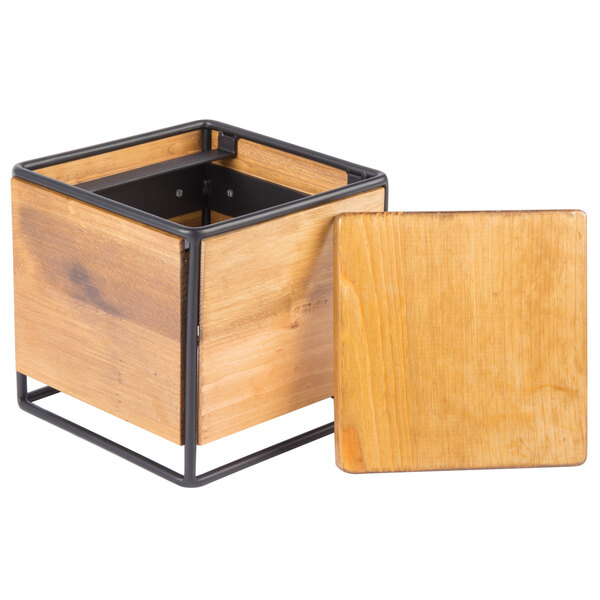 A square wooden display riser with a black metal frame.