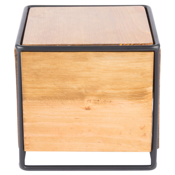 A wood and metal square riser with black metal legs.