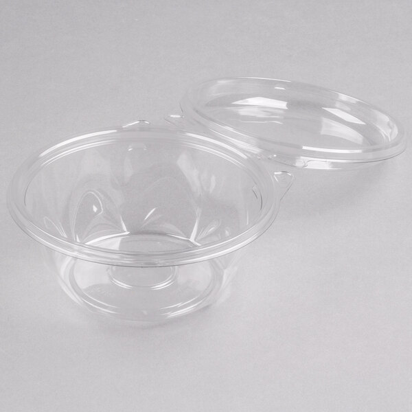 A Dart plastic bowl with a clear dome lid on it.