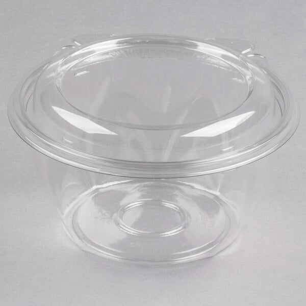 A clear Dart plastic container with a clear plastic dome lid.