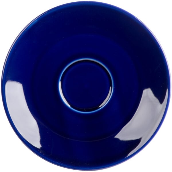 A Tuxton cobalt blue cappuccino saucer with a circle in the middle and a rim.