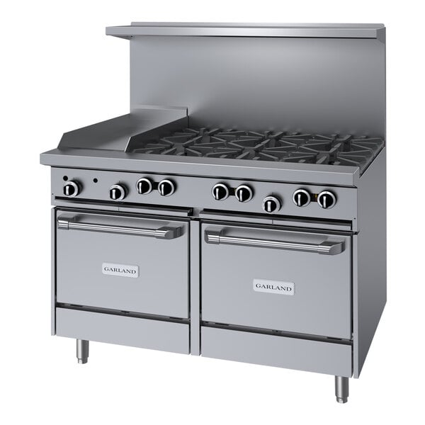 A stainless steel Garland commercial gas range with 6 burners and a griddle over 2 storage bases.