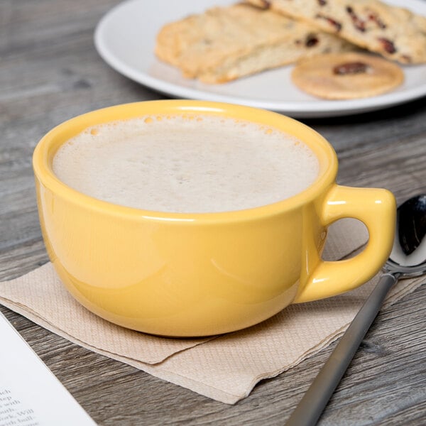 a spoon next to a yellow cup