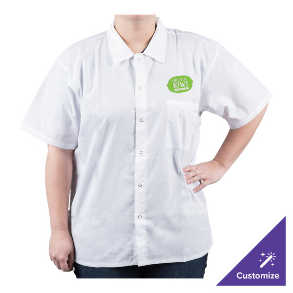 A woman wearing a white Chef Revival cook shirt with a green logo.