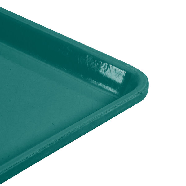 A teal plastic Cambro dietary tray with a handle.
