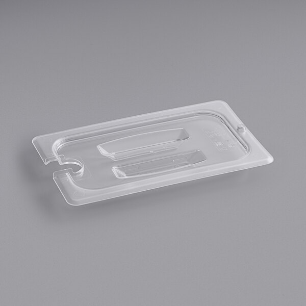A clear plastic container with a handled lid and spoon notch.