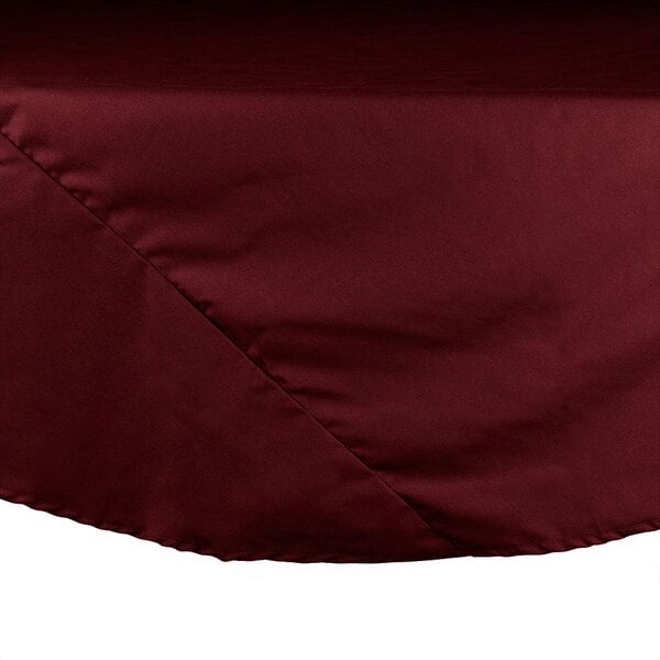 An Intedge burgundy round table cloth on a table.