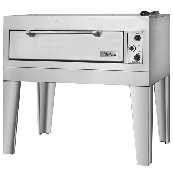 A stainless steel Garland pizza oven on legs with a door.